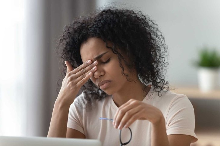 Tired stressed overworked young african woman student feel hurt fatigue eye strain headache after computer work take off glasses suffer from pain in dry eyes, bad vision problem, eyestrain concept